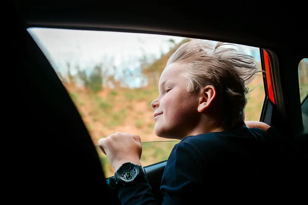 Racyfish majú často silné puto so svojimi blízkymi, čo sa odráža aj v snahe chrániť všetko, čo nosia. - Chlapec nakláňa hlavu z auta
